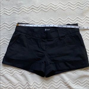 Cuffed black shorts.